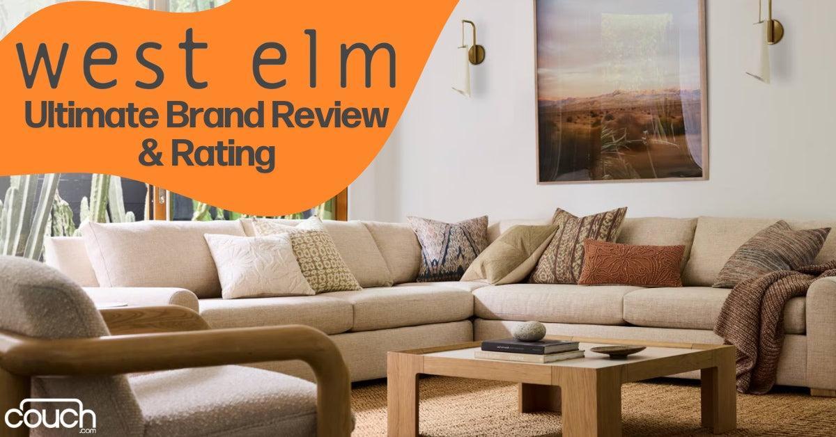 A cozy living room with a large beige sectional sofa, various patterned pillows, a light wooden coffee table, and a wall photo of a desert landscape. Text overlay reads, "West Elm Ultimate Brand Review & Rating" with the Couch.com logo.