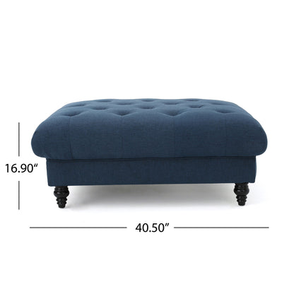 The Madrid - Tufted Ottoman Footrest is a dark blue, rectangular ottoman with black turned legs, measuring 16.9" high and 40.5" wide, shown from the front with labeled dimensions.
