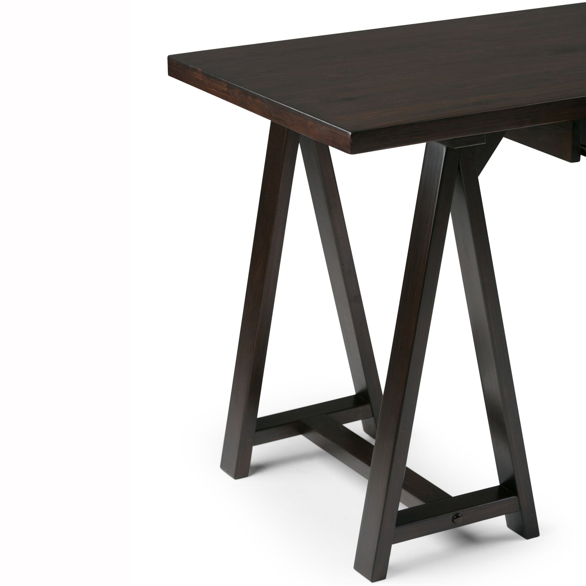 A close-up of the Sawhorse - Handcrafted Desk features a dark wooden rectangular top and sturdy, angled legs with horizontal supports, set against a plain white background.