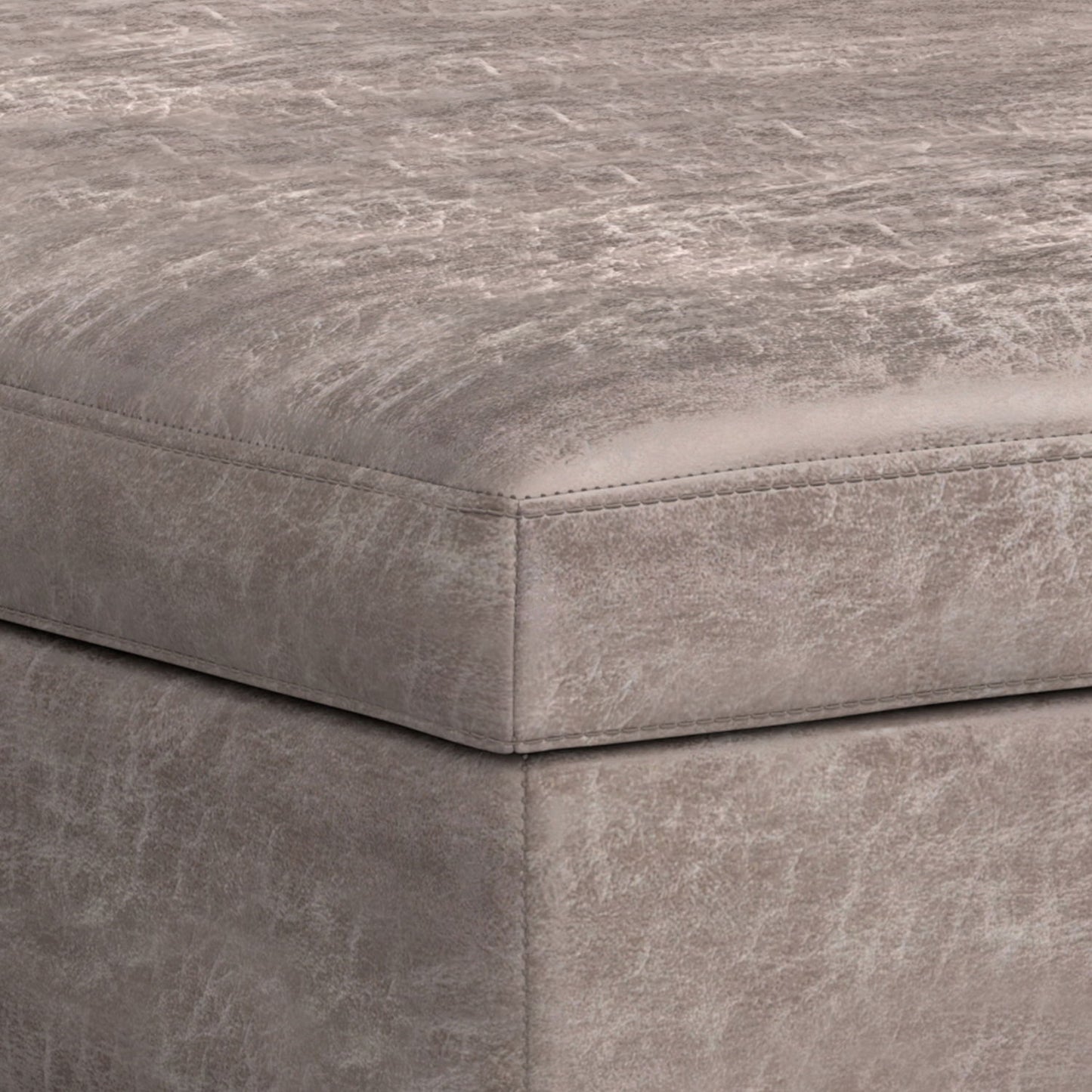 Close-up of the corner of the Owen Multifunctional Square Coffee Table Storage Ottoman, upholstered in distressed light gray leather or faux leather with visible edge stitching.