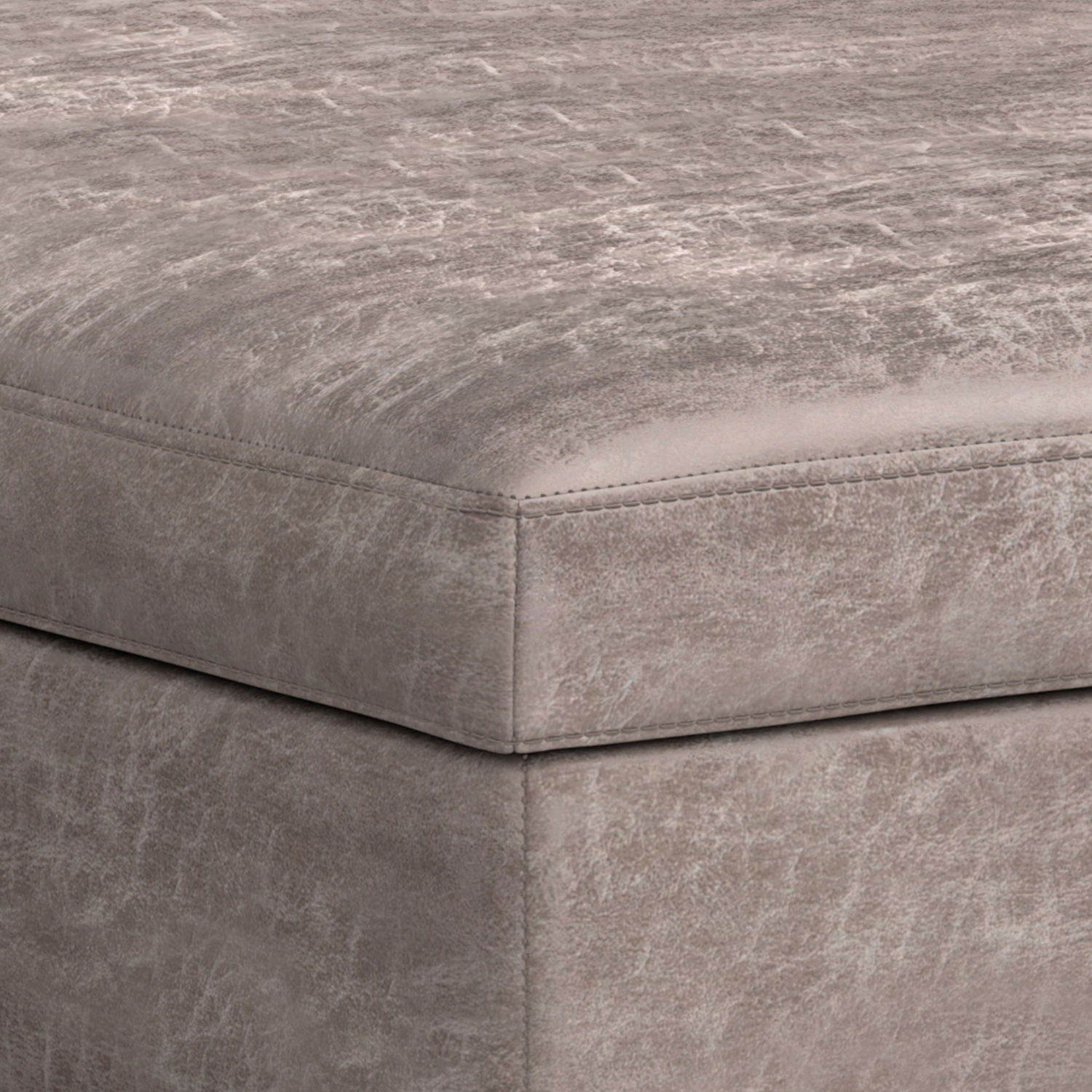 Close-up of the corner of the Owen Multifunctional Square Coffee Table Storage Ottoman, upholstered in distressed light gray leather or faux leather with visible edge stitching.