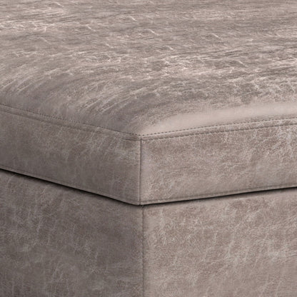 Close-up of the corner of the Owen Multifunctional Square Coffee Table Storage Ottoman, upholstered in distressed light gray leather or faux leather with visible edge stitching.