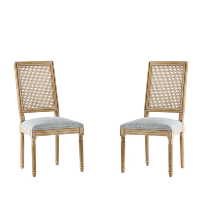 Two French Country Dining Chairs with rectangular cane backrests and smooth upholstered seats, featuring carved legs and a classic, elegant design, are set against a plain white background.