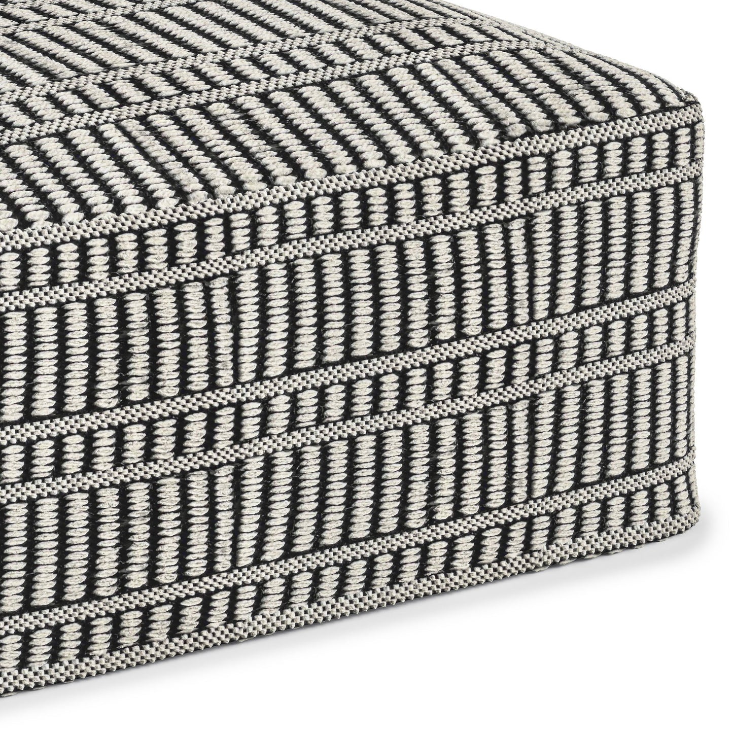 Close-up of the Safford Square Woven Outdoor/Indoor Pouf in black and white, featuring a geometric pattern with horizontal and vertical lines and stripes.