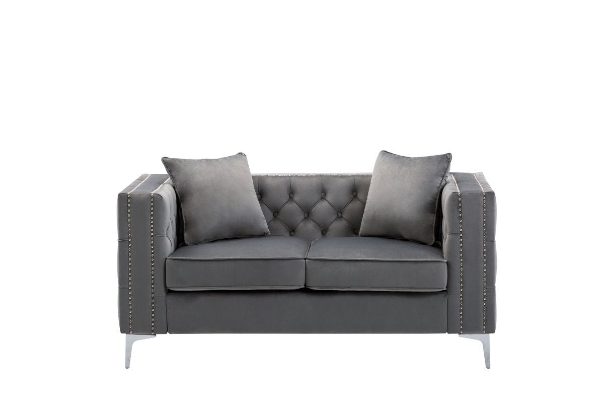 The Lorreto Velvet Loveseat features a modern dark gray design with two matching cushions, tufted backrest, silver metal legs, and nailhead trim on the arms, shown on a plain white background.