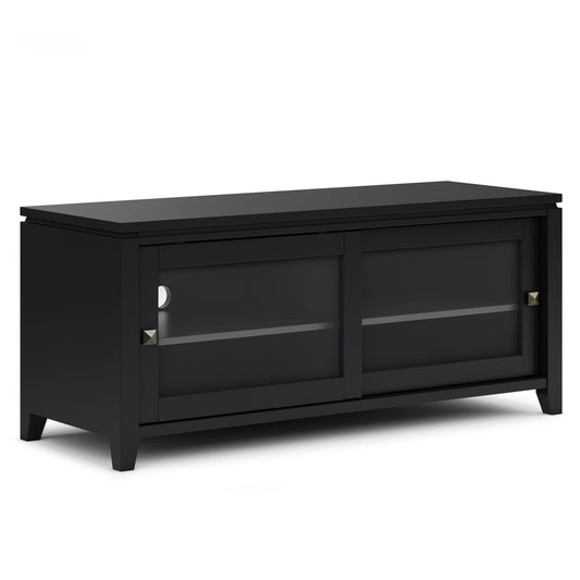 The Cosmopolitan - Handcrafted TV Media Stand is black wood with two sliding glass doors, square metallic handles, an inner shelf, short legs, and a simple modern design.