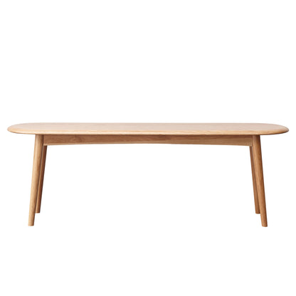 A simple, light wooden Dining Bench, Table Bench For Living Room with rounded edges and four angled legs, photographed against a white background.