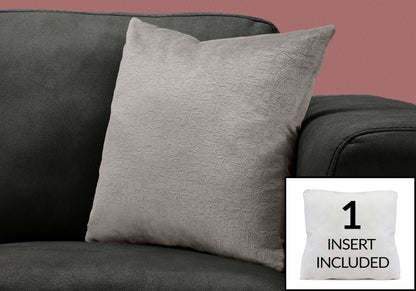 A light gray Pillow Square Decorative Throw pillow with hypoallergenic insert rests on a dark gray sofa. An inset shows the included white insert labeled "1 INSERT INCLUDED." The background wall is pink.