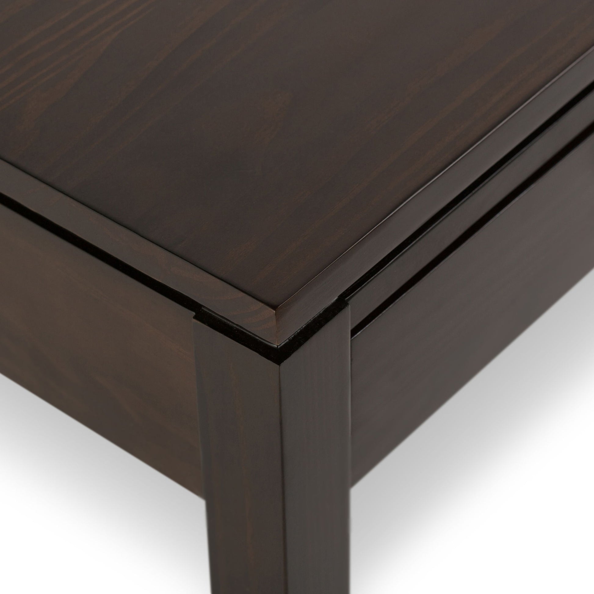 Close-up of the corner of the Cosmopolitan - Multipurpose Table, featuring a dark brown finish, clean straight lines, and a smooth surface.