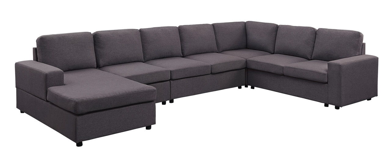 The Tifton Linen 7 Seat Reversible Modular Sectional Sofa Chaise features thick cushions and low armrests in a large, dark gray L-shaped design, shown against a plain white background.