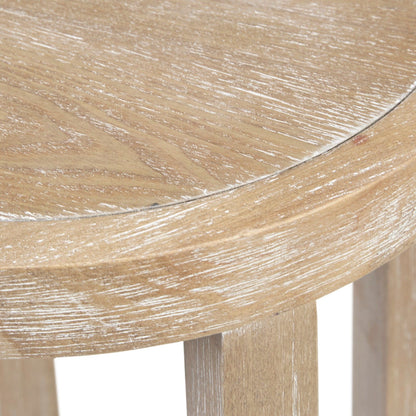 Close-up of the edge of the Accent Table Round Rustic Ash Veneer Reclaimed Wheat - Natural, highlighting its light, weathered finish, visible wood grain, and partially visible three-legged design.