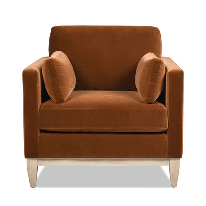 The Knox - Modern Farmhouse Arm Chair features rich brown upholstery, two matching cylindrical side cushions, square arms, and light wooden legs, all showcased against a white background.