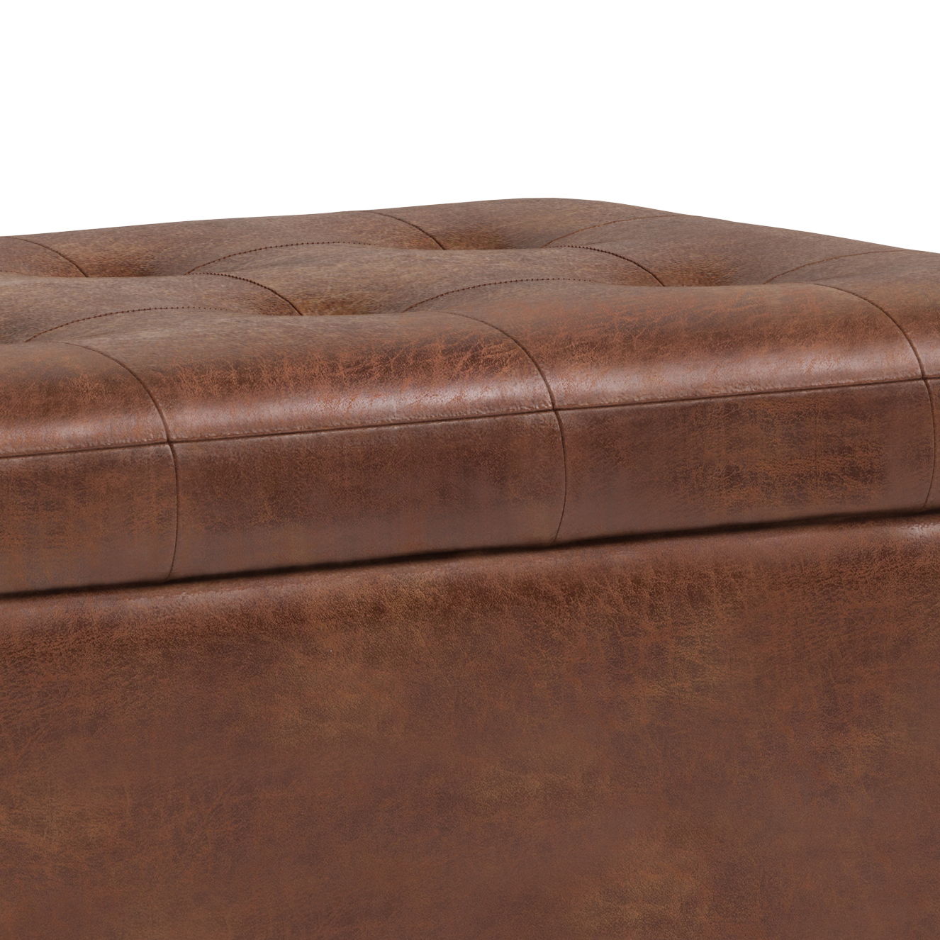 Close-up of the Cosmopolitan - Upholstered Storage Ottoman in brown leather with visible stitching, subtle button tufting on top, and horizontal seam lines on the sides for a slightly distressed look.