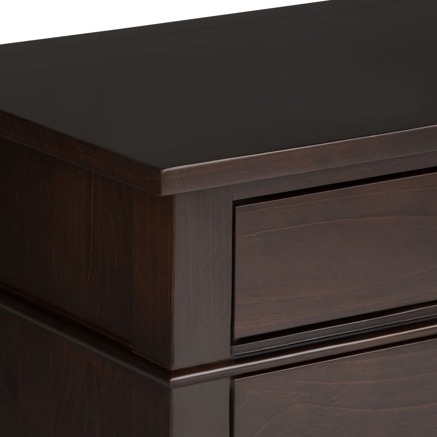 Close-up of the Carlton - Bedside Table, Handcrafted, highlighting the smooth, polished dark wood top corner and part of a drawer with clean, modern lines.
