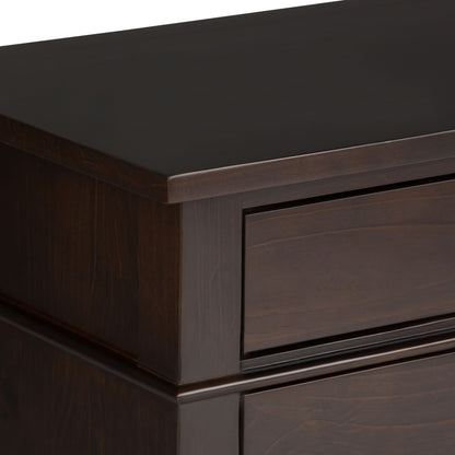 Close-up of the Carlton - Bedside Table, Handcrafted, highlighting the smooth, polished dark wood top corner and part of a drawer with clean, modern lines.
