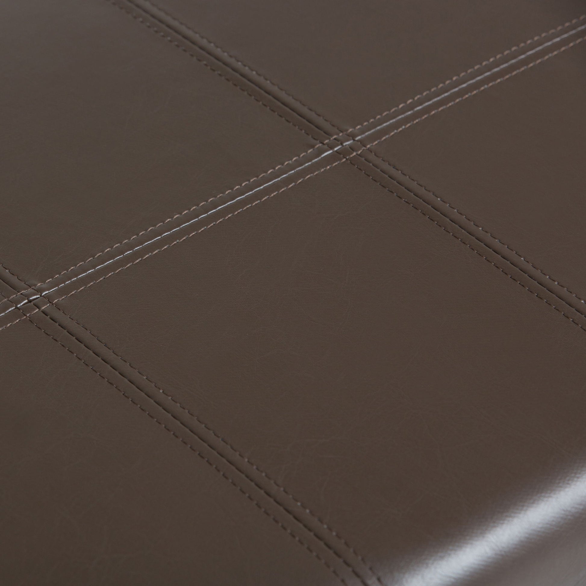 Close-up of the Dover - Upholstered Storage Ottoman Bench, featuring dark brown leather upholstery with visible stitching that forms a grid pattern of squares.