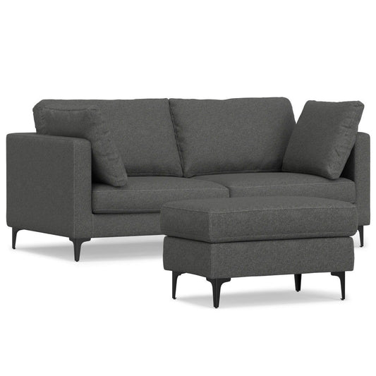 The Ava Mid Century Sofa With Ottoman Set features a modern dark gray sectional with three seat cushions, two matching back cushions, slim armrests, black tapered legs, and a matching rectangular ottoman.