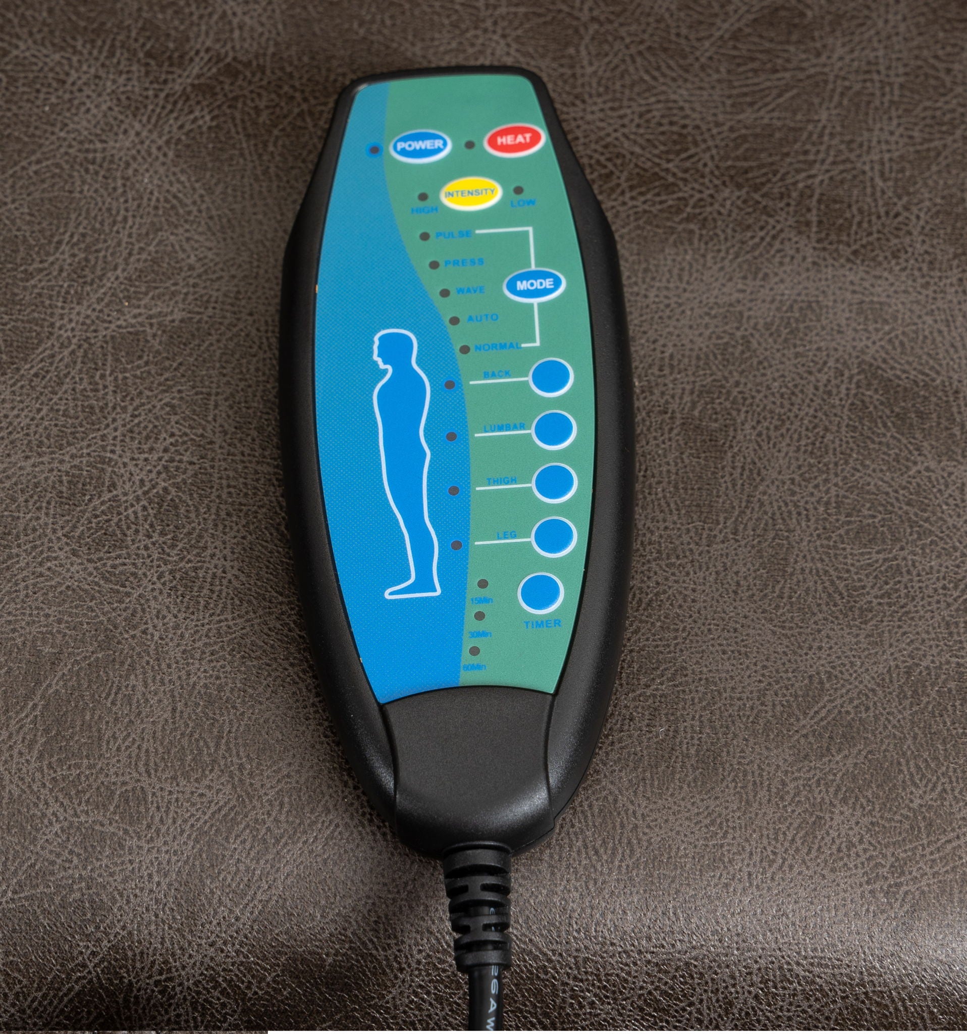 A close-up of the Electric Power Massage Recliner Chair's remote shows labeled buttons for power, heat, intensity, mode, massage areas, and timer on a brown leather surface.