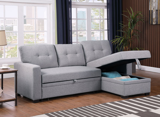 An Upholstered Pull Out Sectional Sofa With Chaise, featuring light gray tufted cushions and hidden storage under the chaise with a blue blanket, sits in a living room with large windows, a plant, and cityscape views.