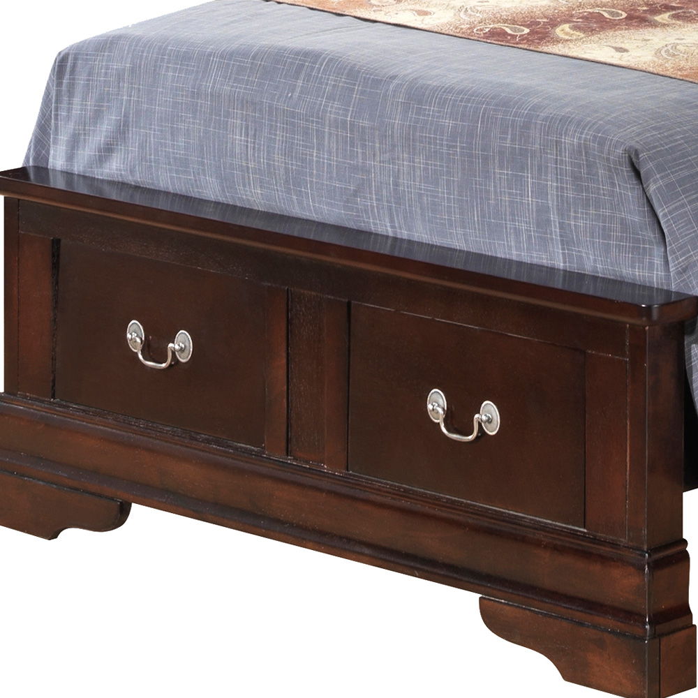 The Louis Phillipe Storage Bed features a dark wooden frame with two silver-handled drawers at the foot, partially covered by a neatly made bed with a blue plaid blanket and patterned runner.