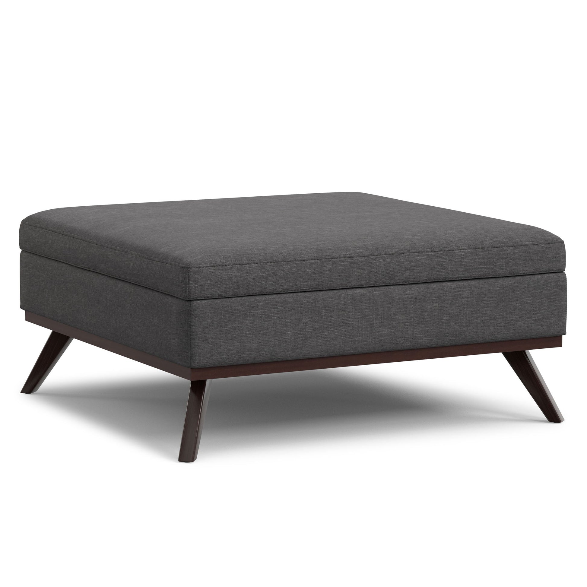 The Owen Multifunctional Square Coffee Table Storage Ottoman features dark gray upholstery, a cushioned top, and angled wooden legs with a dark finish.
