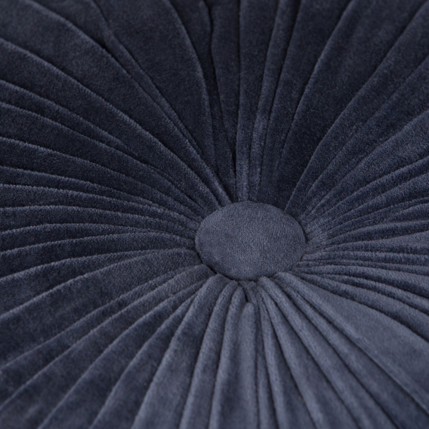 Close-up of the Renee - Handcrafted Round Pouf, featuring dark gray velvet with radiating pleats and a central button for a textured, flower-like look.