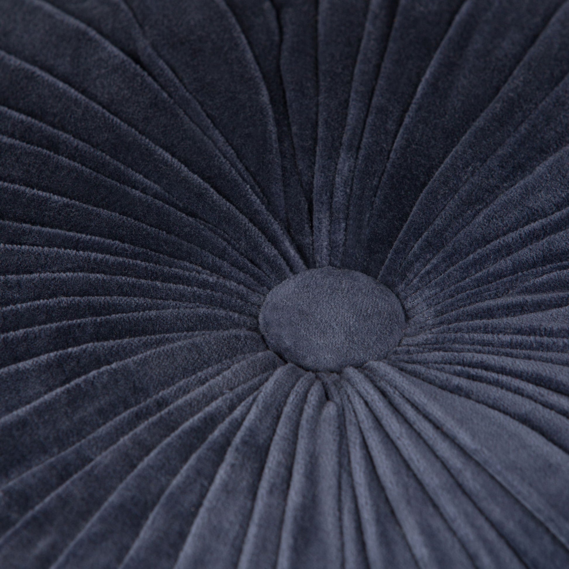 Close-up of the Renee - Handcrafted Round Pouf, featuring dark gray velvet with radiating pleats and a central button for a textured, flower-like look.