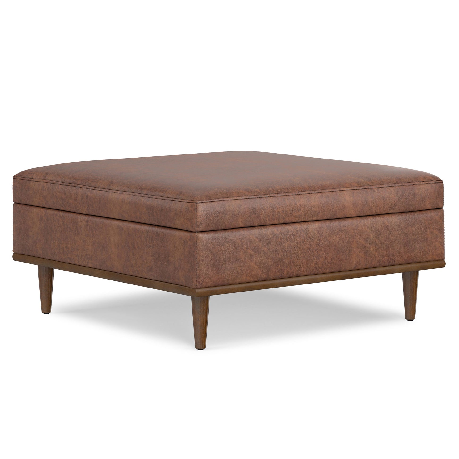 The Shiloh Multifunctional Square Storage Ottoman showcases a brown leather finish, tapered wooden legs, a smooth cushioned top, and a sleek mid-century modern design.