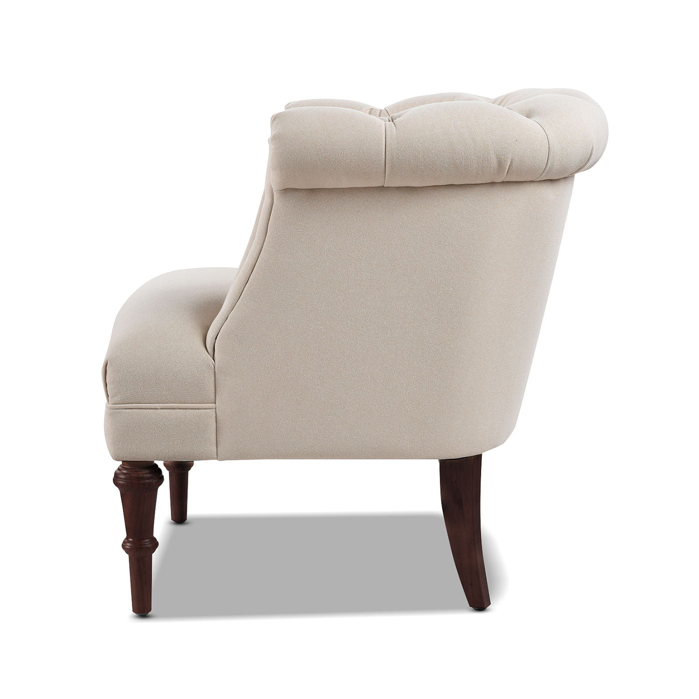 A side view of the Katherine - Tufted Accent Chair, featuring beige upholstery, a tufted backrest, and dark wooden legs against a white background.