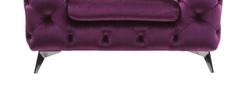 The Atronia - Chair features an elegant design with deep purple velvet upholstery, tufted detailing, angled metal legs, and a matching cushion, shown against a white background.
