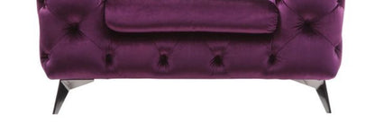 The Atronia - Chair features an elegant design with deep purple velvet upholstery, tufted detailing, angled metal legs, and a matching cushion, shown against a white background.