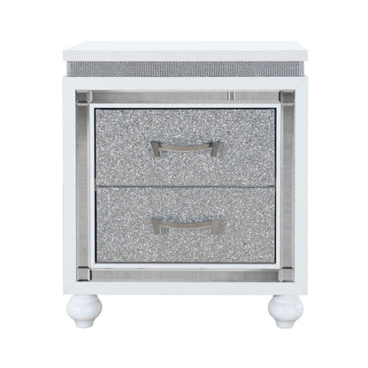 The Couch.com Maloise Nightstand features a modern white and gray finish, durable wood construction, storage with silver drawers and handles, decorative trim, and stands on four rounded white legs.