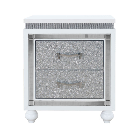 The Couch.com Maloise Nightstand features a modern white and gray finish, durable wood construction, storage with silver drawers and handles, decorative trim, and stands on four rounded white legs.