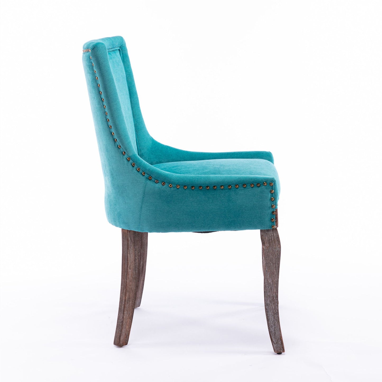 The Ultra Side Dining Chair features thickened fabric in teal, neutrally toned solid wood legs, and bronze nailhead trim, shown in profile against a white background. Comes as a set of 2.