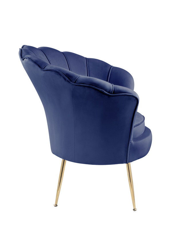 The Angelina Velvet Scalloped Back Barrel Accent Chair with metal legs is shown from a rear side angle against a white background, featuring blue velvet upholstery, tufted scallop details, gold tapered legs, and a curved backrest.