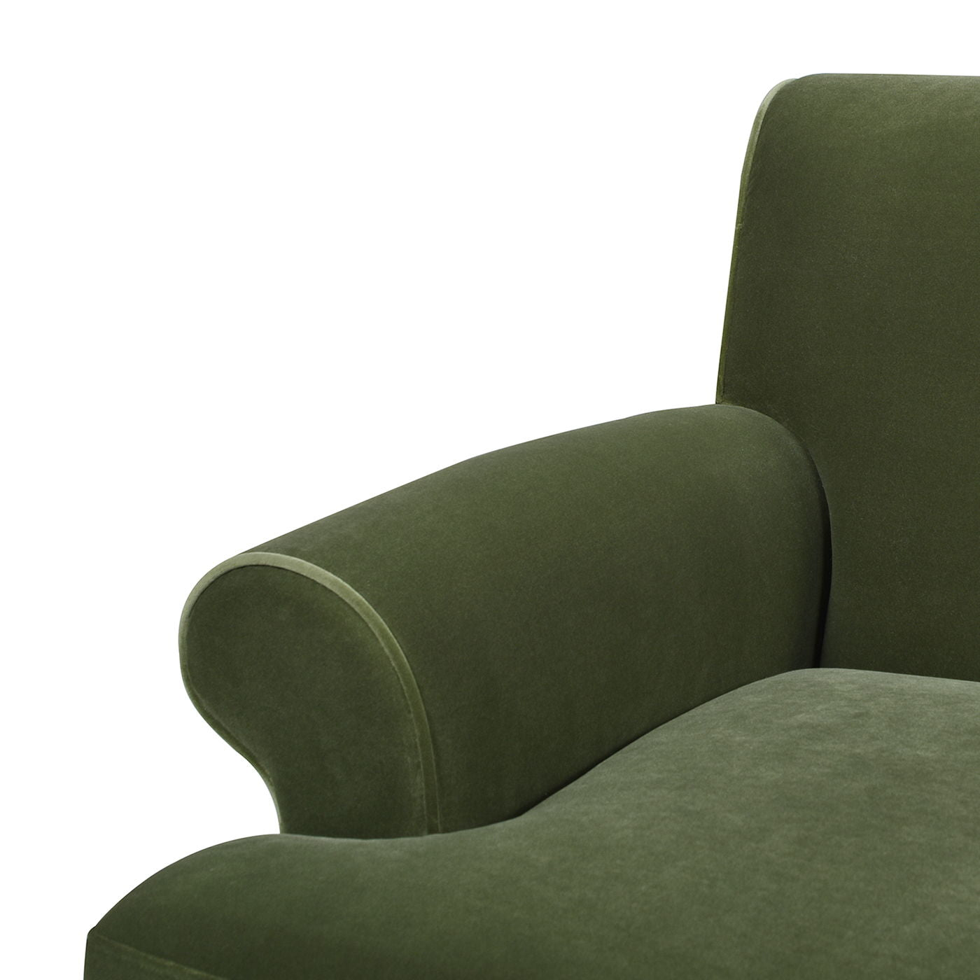 Close-up view of the Alana Lawson - Three Cushion Tightback Sofa in green velvet, showing part of the seat, curved armrest, and a portion of the backrest against a white background.