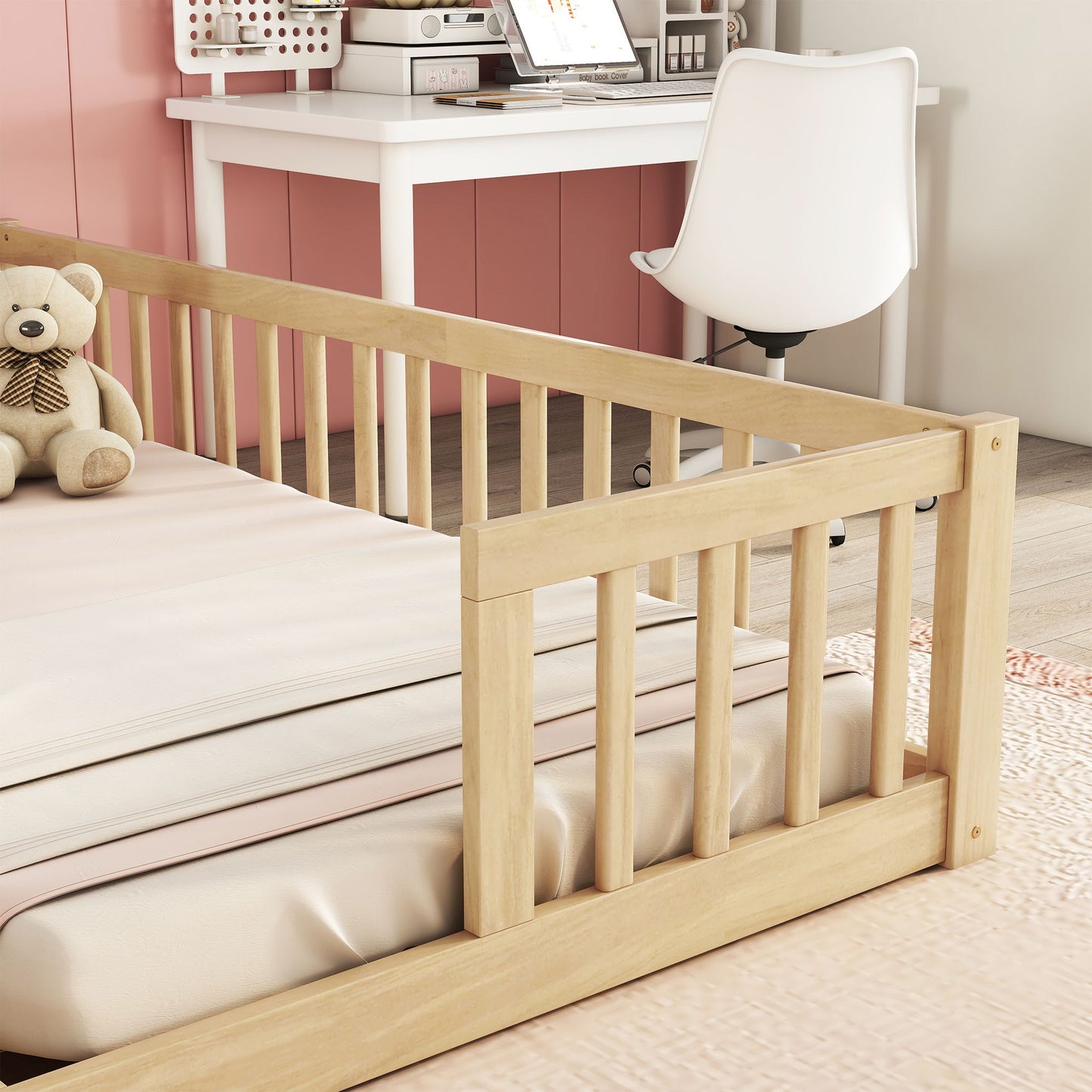 A close-up of the Double Floor Bed With Fence, Guardrails, Without Door in light wood, featuring a teddy bear on the mattress, set in a room with a pink paneled wall, white desk and chair, and peach-colored rug.