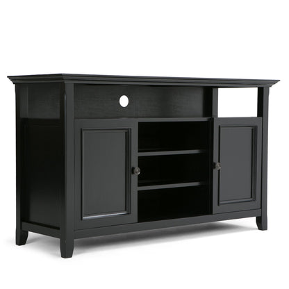 The Amherst TV Media Stand is handcrafted in black wood, featuring two side cabinets, two central open shelves, and a spacious open area above with a circular cable management hole at the back.
