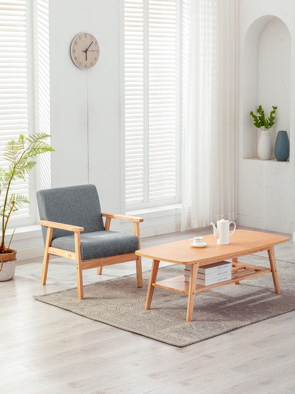 A cozy, modern living room featuring the Bahamas Coffee Table and Chair set, a potted plant, a clock on a white wall, decorative vases on shelving, and large windows with blinds.