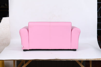 The Kids Club Chair Sofa / Sectional And Ottoman - Pink features a small, bright pink design with rounded arms and backrest, set on a wooden platform against a plain white background.