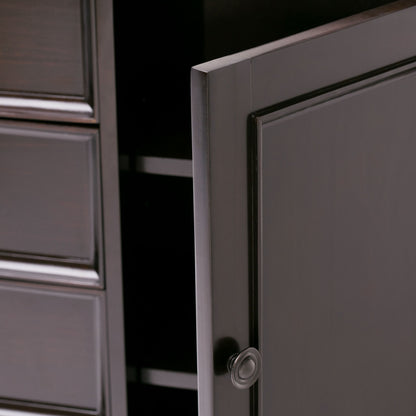 Close-up of the Amherst - Handcrafted Medium Storage Cabinet in dark wood, featuring a partially open door with a round knob revealing shelves inside, and three panel drawers visible on the left.