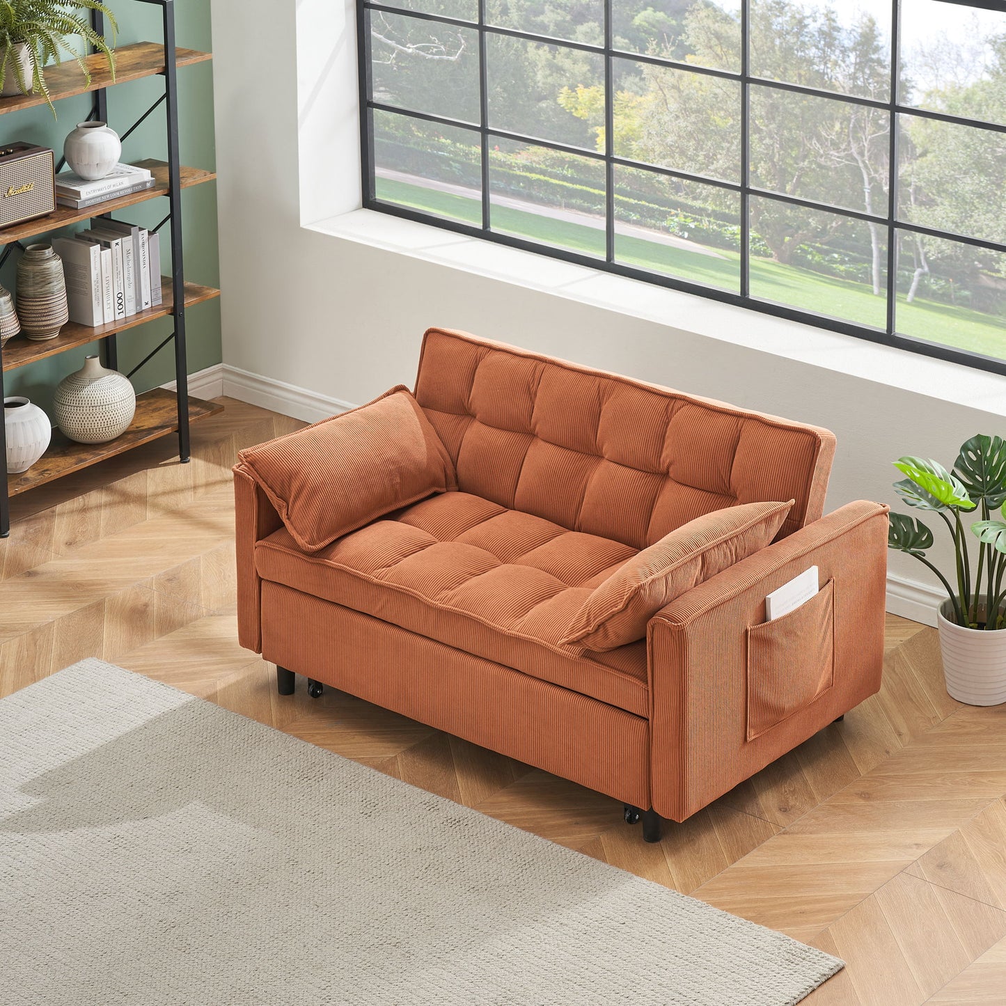 A Folding Sofa Bed With Adjustable Back serves as a cozy single bed or recliner in a sunlit room with a wooden floor, near a window. A small pocket on its arm holds a book; pillows, shelf decor, and a rug complete the inviting space.