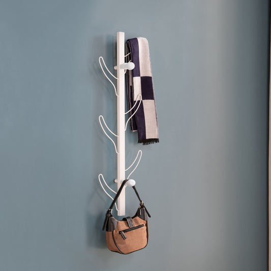 The Vertical Eight Hook Coat Rack Wall Mount, in modern white, displays a black-and-white checkered scarf and a small tan handbag against a plain blue wall.