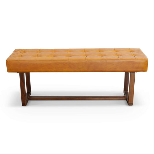 The Cameron Bench in brown/tan features a rectangular design with tufted leather cushioning and a dark wooden base, shown on a white background.