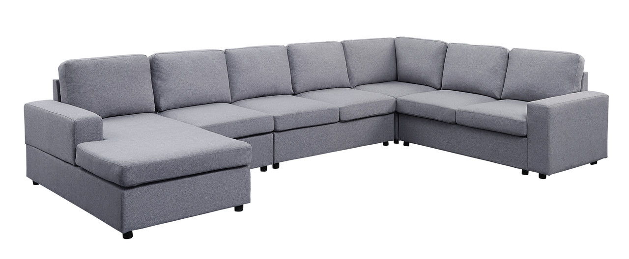 The Hayden Linen 7 Seat Reversible Modular Sectional Sofa Chaise features light gray upholstery, thick cushions, a left-side chaise lounge, and short black legs in a spacious L-shaped design.