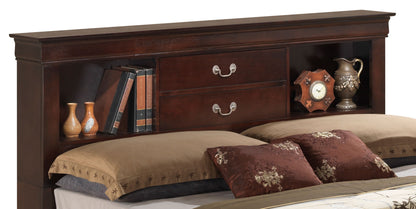 The Louis Phillipe Bookcase Storage Bed features a dark wood headboard with two central drawers, open shelves for books and décor like vases, a clock, and a pitcher, all set behind plush pillows and bedding.