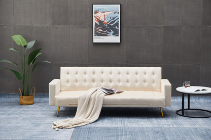 A modern living room featuring the Comfort Compact Design Sofa Bed in cream, a beige knit blanket, open magazine, round white side table with book and glass, potted plant, and framed abstract artwork on a dark wall.