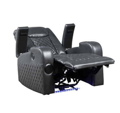 The Alair Leather Aire Power Motion Recliner in dark gray features quilted patterns, padded armrests, a cup holder, blue LED base lighting, and is in a partially reclined position. It includes Bluetooth and a wireless charger.