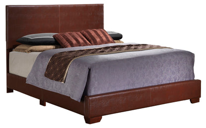 The Elegant Platform Bed For Relaxed Spaces features a tall brown leather headboard and frame, dressed in gray and beige bedding with two stacked pillows and two decorative brown striped accent pillows.