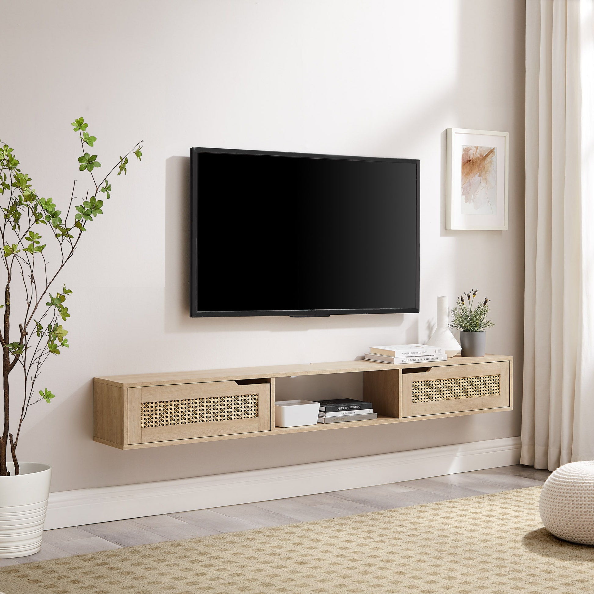 A modern living room features a Modern Rattan Door Floating TV Stand for TVs up to 80", wall-mounted flat-screen TV, potted plant, framed artwork, and neutral decor on a beige rug. Light curtains hang by the window on the right.